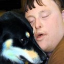 Boy with Down Syndrome hugging a dog